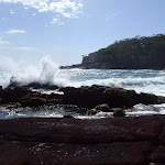 Waves crashing into red sands bay (103015)