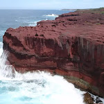 Red cliffs with waves crshing (105286)