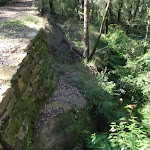 A retaining wall supporting Shepherd's Gully road (162946)